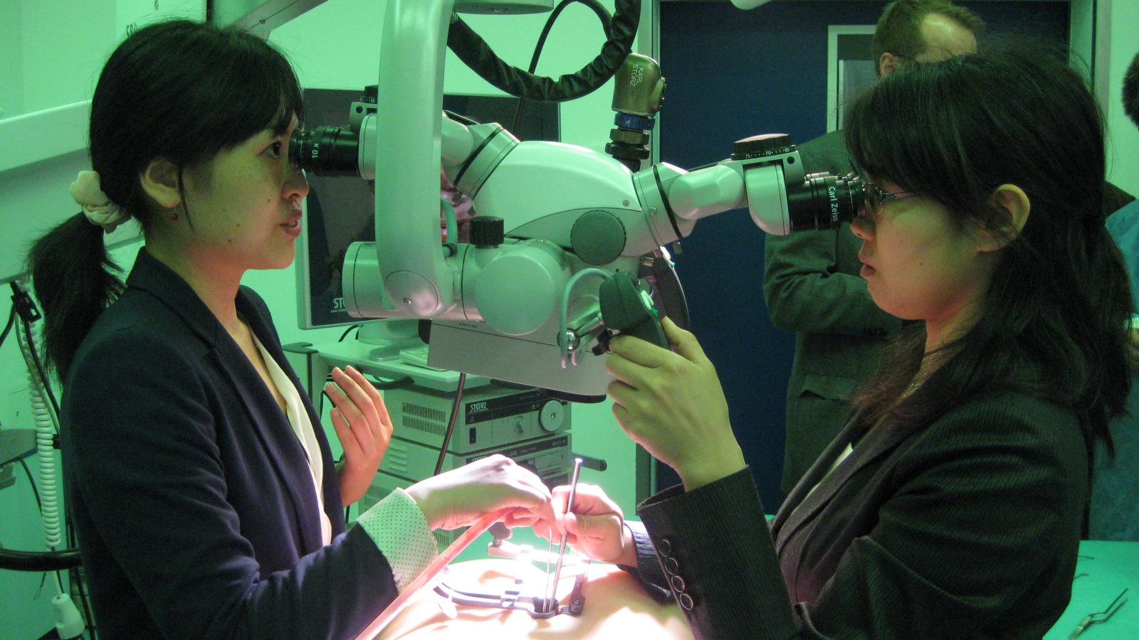 Two participants are using medical technology